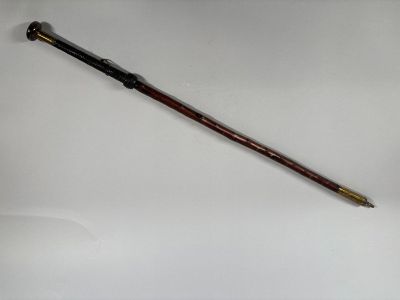 a close up of a pen on a white surface with a white background