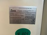a close up of a white refrigerator with a green sticker on it