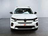 the front of a white car is parked in a white room
