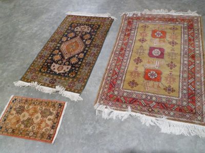 three rugs on the floor are laid out on the floor