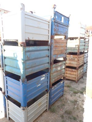 many crates stacked on top of each other in the dirt