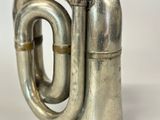 a silver metal instrument that is sitting on a table