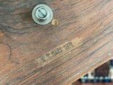 a close up of a wooden table with a metal knob