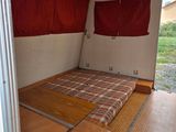 a bed in the back of a truck with red curtains