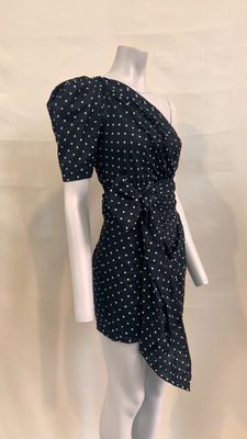 the mannequin is wearing a black dress with white polkas