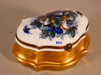 a white and gold box with blue flowers on it