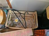a box of empty glasses and a pair of scissors in it