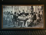a painting of a group of people sitting at a table