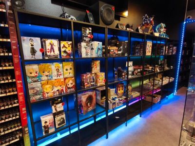 a large display of toys in a store with blue lights
