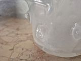 a frosty glass pitcher sitting on a table