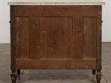 a wooden cabinet with a marble top on a tile floor