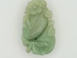 une photo d'une sculpture en jade vert représentant un Bouddha