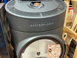 a black stove sitting next to a refrigerator in a store