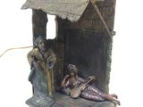 a figurine of a man and a woman sitting in a manger