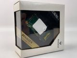 a white box with a green and white electronic device inside of it