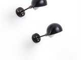 pair of black wall lamps on a white background