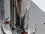 a close up of a metal object with dirt on it
