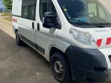 a white van parked in front of a building