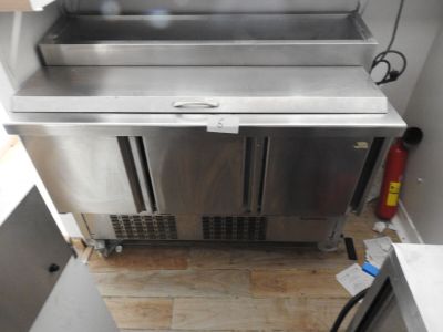 a stainless steel sink in the corner of a kitchen
