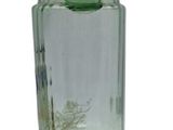 a green glass vase that is sitting on a table