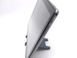 a tablet computer sitting on a stand on a white surface