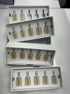 three boxes of perfumes are stacked on top of each other on a table