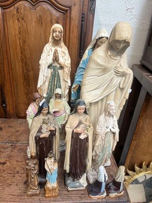 a statue of a woman and a man and a group of figurines on a table