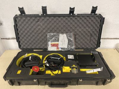 a black case with a yellow and black device in it