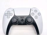 a close up of a video game controller on a white surface
