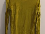 a yellow sweater hanging on a wall next to a hanger