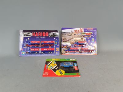 two toy trains on the table next to each other