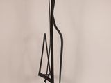 a black metal sculpture of a man holding a knife and a book