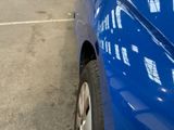 a blue car that is parked in a parking lot