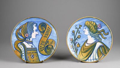 pair of painted plates depicting two women and a banner