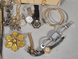 many different types of watches and bracelets laid out on a table