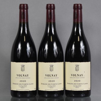 three bottles of red wine sitting on top of a table
