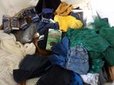 a suitcase full of clothes and other items on a bed