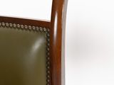 a chair with a green leather seat and a wooden frame