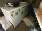 an image of a refrigerator in a room with a lot of stuff