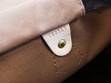 the inside of a tan and black purse with a leather handle