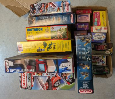a lot of different toys and games on the floor
