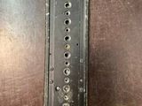 a close up of a piece of metal with holes in it