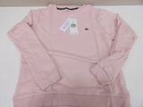 a close up of a pink sweatshirt with a tag on it