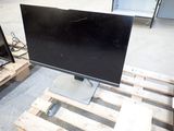 two monitors sitting on a pallet next to each other