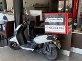 a scooter that is parked in front of a vespa
