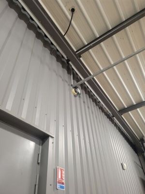 a metal building with a door and a light on it