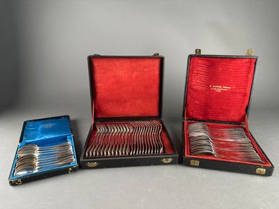 two cases with silverware in them sitting next to each other