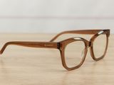 a pair of glasses sitting on top of a wooden table