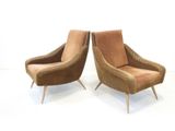 pair of mid century style lounge chairs with brown upholstered cushions