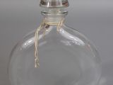 a clear glass bottle with a knot on the top
